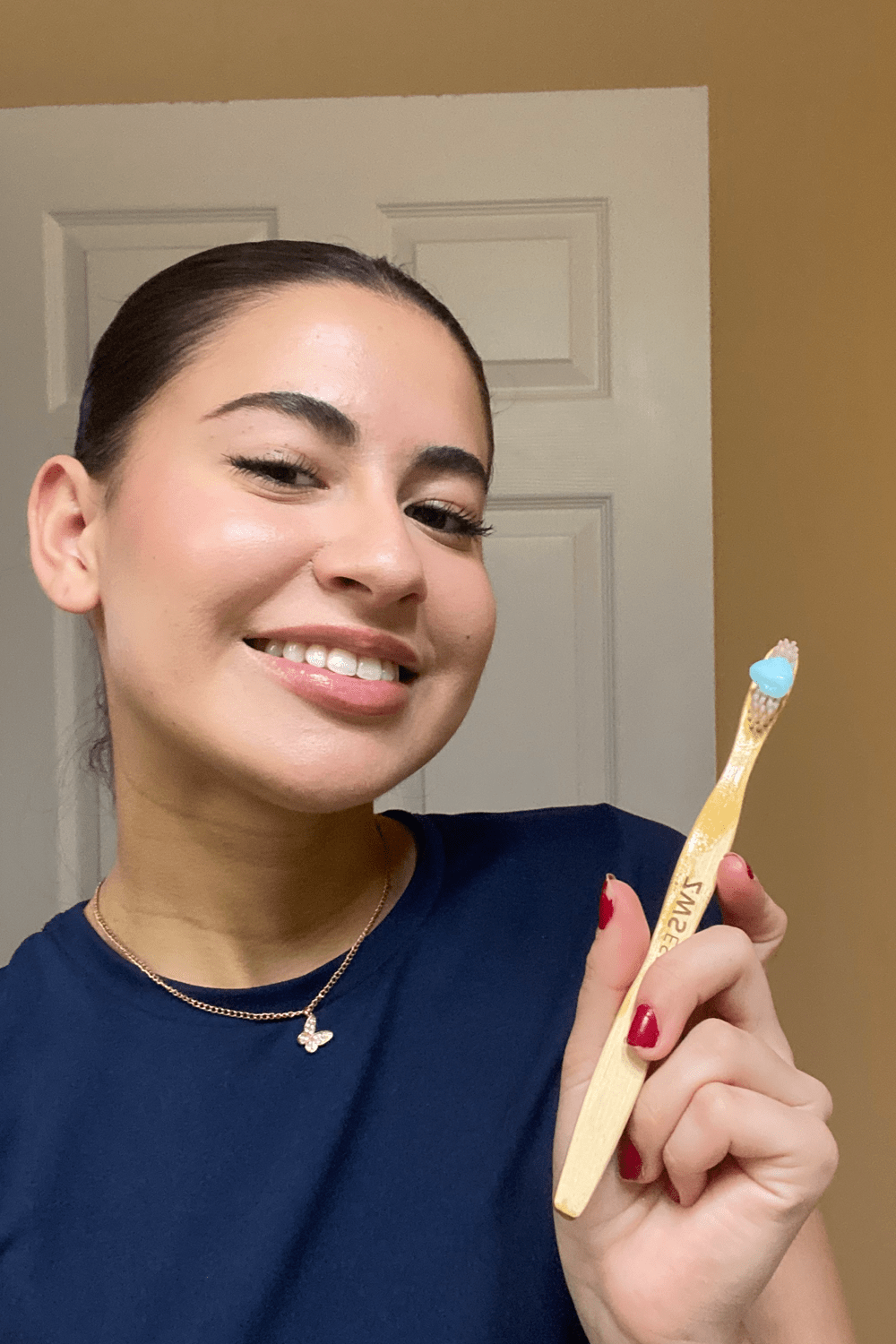 bella holding bamboo toothbrush bella holding bamboo toothbrush