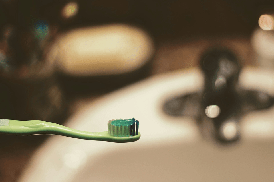 Photo by Joshua Hoehne on Unsplash green plastic toothbrush with toothpaste