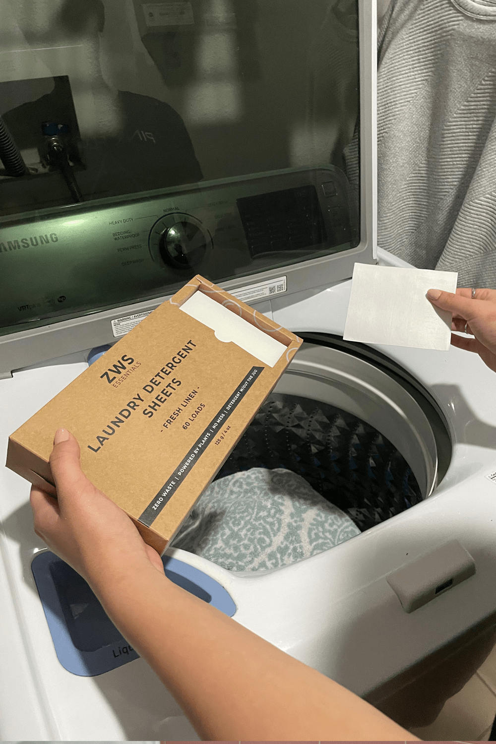 model placing laundry detergent sheets in wash model placing laundry detergent sheets in wash