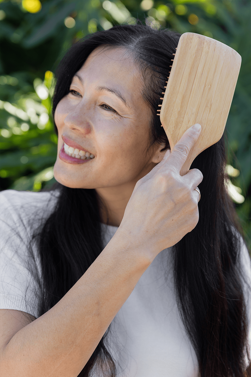 older women brushing her hair with bamboo hair brush older women brushing her hair with bamboo hair brush