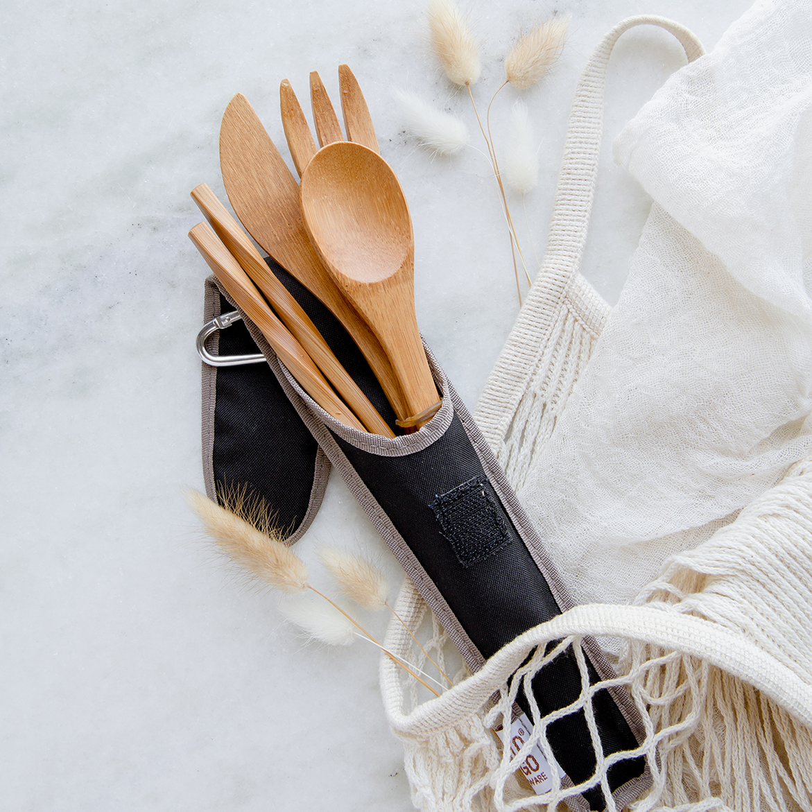 Bamboo fork, knife, spoon, and chopstick set in a black sleeve.